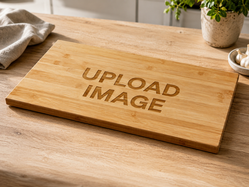 A rectangular bamboo cutting board with 'UPLOAD IMAGE' engraved on the top, displayed on a wooden countertop with a plant and garlic in the background.