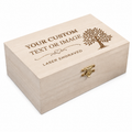 A light natural wood keepsake box with a gold-tone clasp, featuring a laser-engraved customizable design on the lid with a tree illustration and placeholder text.