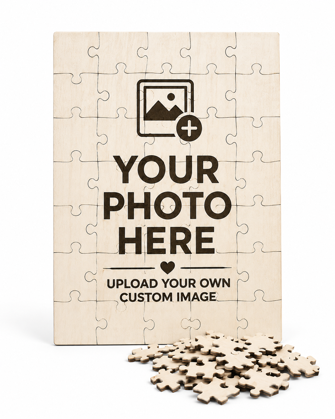 A wooden jigsaw puzzle mockup with a light natural wood finish, featuring a printed template design with the text 'YOUR PHOTO HERE' and 'UPLOAD YOUR OWN CUSTOM IMAGE' on a white background, with several loose puzzle pieces scattered in front.